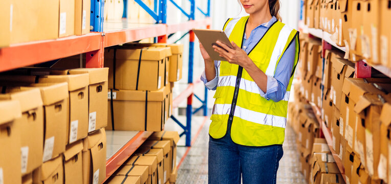 Portrait engineer woman shipping order detail on tablet check goods and supplies on shelves with goods background inventory in factory warehouse.logistic industry and business export