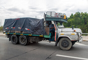 An old truck is driving on the highway, Thailand