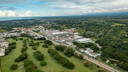 View of a beautiful golf course in Honiara with sports stadiums and facilities across the main road from it. 