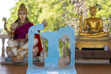 Fototapeta na wymiar A broken plastic chair in a Buddhist temple, Thailand