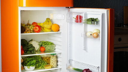 Modern open refrigerator full of many different products