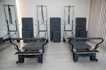 Two reformer machines. Pilates studio without people. 