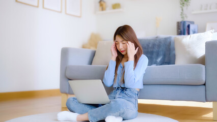 Office syndrome. Overworked tired young asian woman feeling headache, having eyesight problem after computer laptop work. Stressed young woman suffering from fatigue at home