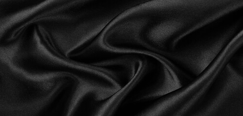 Smooth elegant black silk or satin luxury cloth texture background.