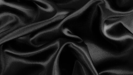Smooth elegant black silk or satin luxury cloth texture background.