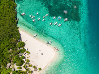 Aerial view of beautiful tropical beach with tourists. Virgin Island, Philippines.