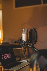 A close up of a podcast microphone in a home podcast studio