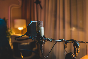 A close up of a podcast microphone in a home podcast studio