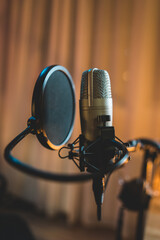 A close up of a podcast microphone in a home podcast studio - obrazy, fototapety, plakaty