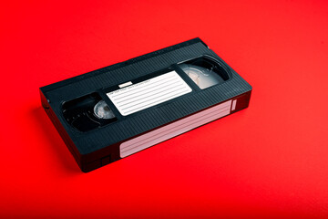 VHS Tape- Video Tape on Red Background. VHS Tape, a staple of an age before streaming, when movie...