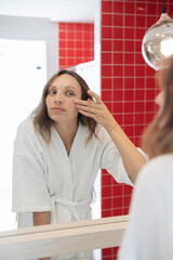 beautiful woman doing skincare in the morning