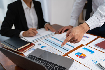 Asian businessman pointing at laptop computer screen discussing on financial services and management issues.