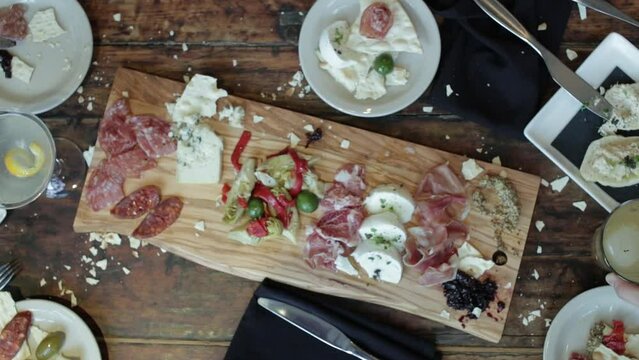 Friends cheers over dinner table at trendy restaurant. Opening or ending brand shot.