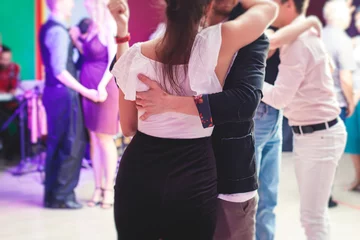 Papier Peint photo École de danse Couples dancing traditional latin argentinian dance milonga in the ballroom, tango salsa bachata kizomba lesson in the red and purple lights, festival, lesson class in dance school class academy