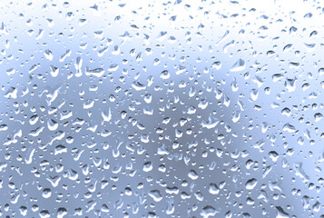 Rain (water) drops on glass, blue glass