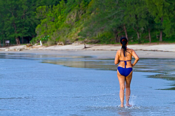 Woman with swimsuit relax morning at beach Hat Wanakon