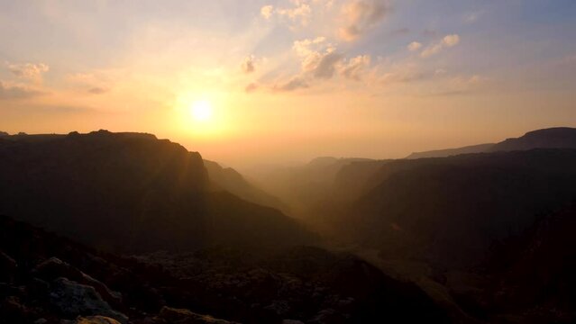 Time lapse of sunset over Dana Biosphere Reserve and Rift Valley in Jordan, epic rugged mountainous canyon view in Middle Eastern landscape