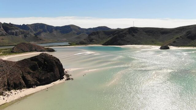High aerial over Balandra Bay in Baja Sur at low tide with shallow clear turquoise water