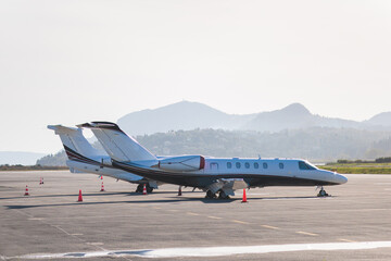 View of modern private reactive aircraft on an runway airfield ready to take off, airstrip with...