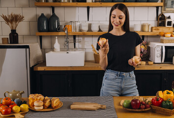 Young woman eating pizza and laughing while sitting with her friends in a restaurant. Group of friends enjoying while having food and drinks at cafe.