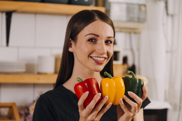 Young woman eating pizza and laughing while sitting with her friends in a restaurant. Group of friends enjoying while having food and drinks at cafe.