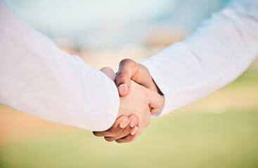 Handshake, fitness and outdoor showing team support, community and collaboration. Field, wellness and sport game partnership shaking hands at s sports club with exercise agreement and athlete deal