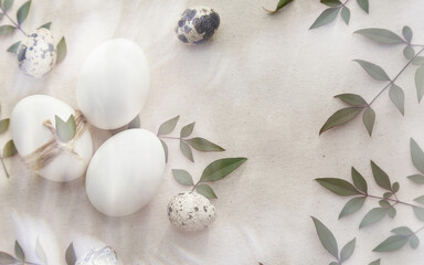 Natural Easter eggs, quail eggs on a rustic linen napkin on the table. 