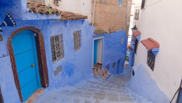 Quiet blue street, alleys of Chefchaouen in Morocco. Tilt down