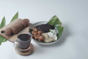 Bubur sum sum or Bubur merah putih.Traditional Indonesian dessert made from sweet glutinous rice, coconut milk, and pandanus leaf, topped with a sprinkle of red and white sugar. Closeup