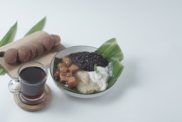 Bubur sum sum or Bubur merah putih.Traditional Indonesian dessert made from sweet glutinous rice, coconut milk, and pandanus leaf, topped with a sprinkle of red and white sugar. Closeup