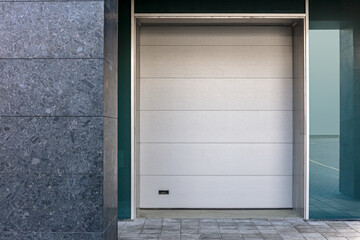 closed roller shutter door on building facade. urban background. architecture.