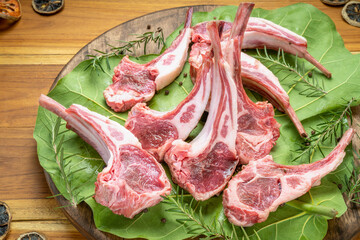 Australian lamb rack cutlets or Raw Frenched Rack 8 Ribs on wooden plate.