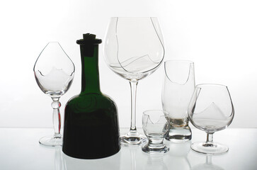 A bottle of wine on the background of broken wine glasses. Stop alcohol symbol.