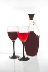 Two glasses of wine and one bottle.Isolated on white.