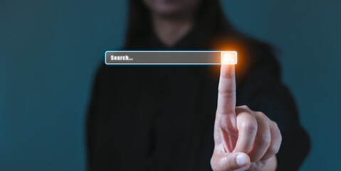 Data search technology browsing Internet data information Networking. Businesswoman pressing search button on virtual screen searching for information. Search Engine optimization concept.
