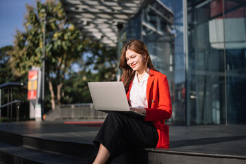 Portrait of Asian business woman holding laptop.Office worker at business center.