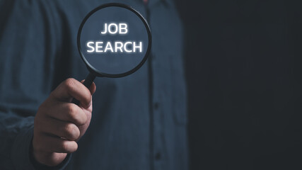 Businessman holding a magnifying glass with search job text ,concept Job search, find a job, unemployment, recruitment, job interview,Search Engine Optimization,job search technology