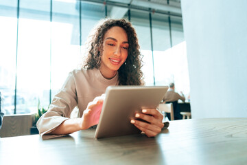 Young woman using digital tablet at cafe