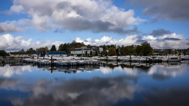 Timelapse of Carrick on Shannon town in county Leitrim and Roscommon with boat traffic, people and moving clouds on river Shannon in Ireland.