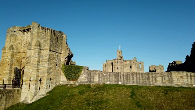 Warkworth Castle in Northumberland, England, UK. Footage shows different views panning across the facade of the castle walls.