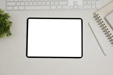 Modern workspace top view with keyboard, book, decor plant, stylus pen and digital tablet