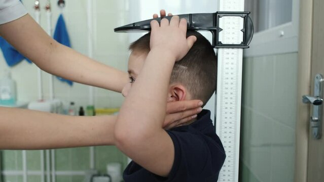 close-up of a boy having his height measured in a medical office