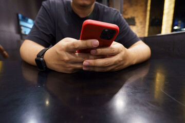 Man playing game on mobile phone. gamer boy playing video games holding Smartphone working mobile devices. cell telephone technology e-commerce concept.