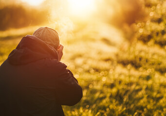 Man taking photo landscape with a big professional camera