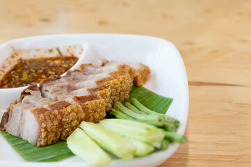 Crispy fried pork belly on a white plate