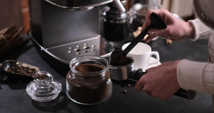 Woman Making Ground Coffee with Tamping fresh coffee into portafilter