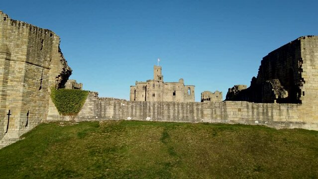 Warkworth Castle in Northumberland, England, UK. Footage shows different views panning across the facade of the castle walls.