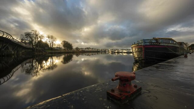 Timelapse of Carrick on Shannon town bridge in county Leitrim and Roscommon with traffic, people and moving sunset evening clouds on river Shannon in Ireland.
