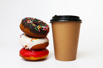 a paper craft cup with coffee or tea and donuts of different flavors on a white background  