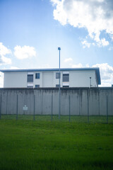 Fototapeta na wymiar A prison, with gray high walls and barbed wire concrete walls and dreary 